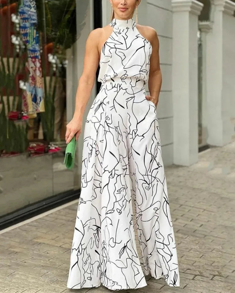 Chic Summer Women's Sleeveless Geometric Print Jumpsuit with Cinched Waist Tie and Elegant Hanging Neck Design.