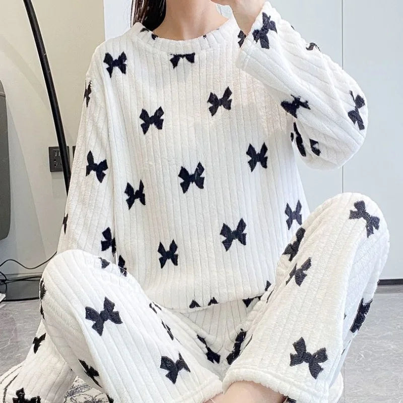Cozy Women Pajama Set with Loose Top and Elastic Waist Wide Leg Fleece Pants Soft Bow Detail for autumn winter lounging.