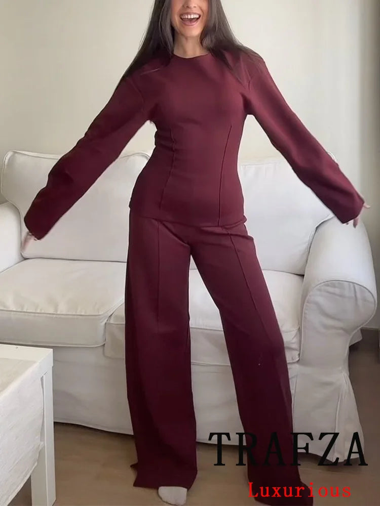 Stylish model showcasing the Casual Chic Red Women Elastic Two-Piece Set Long Sleeve Slim O Neck Top with High Waist Wide Leg Pants.