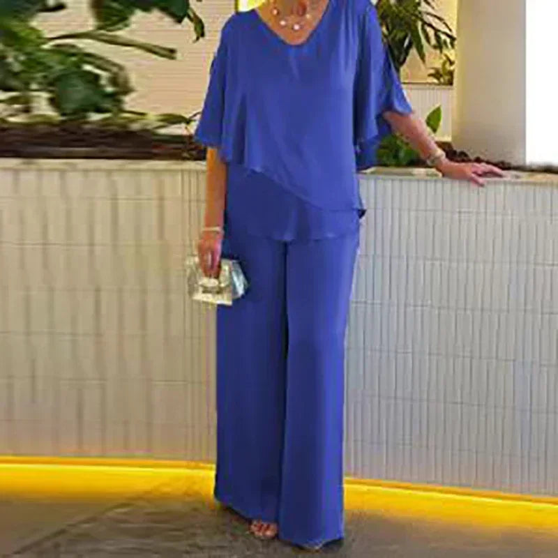 Stay chic this summer in the Elegant Women's Summer Two Piece Set with V-Neck Irregular Top and High Waist Wide Leg Pants.