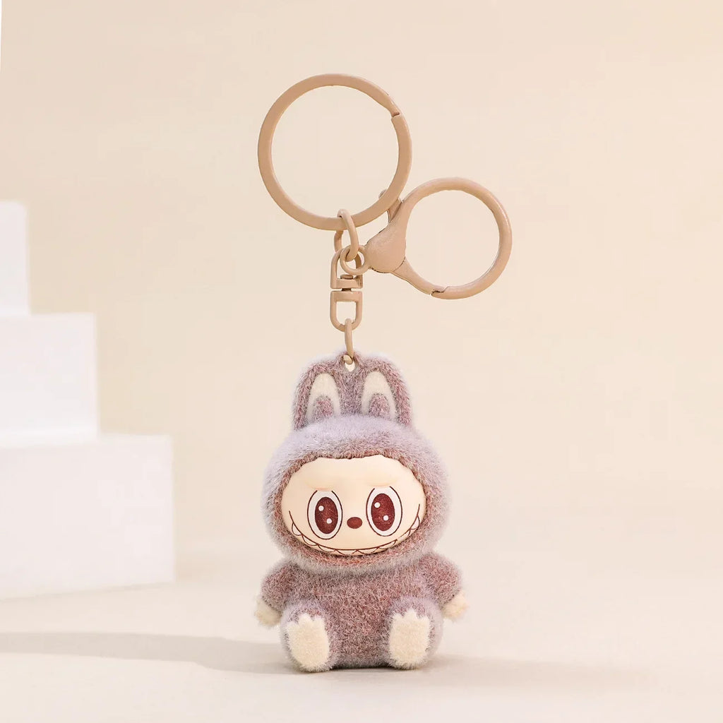 Sitting Labubu Doll Keychain Fluffy PVC Phone Ornament adds charm to bags and keys, perfect as a Christmas gift.