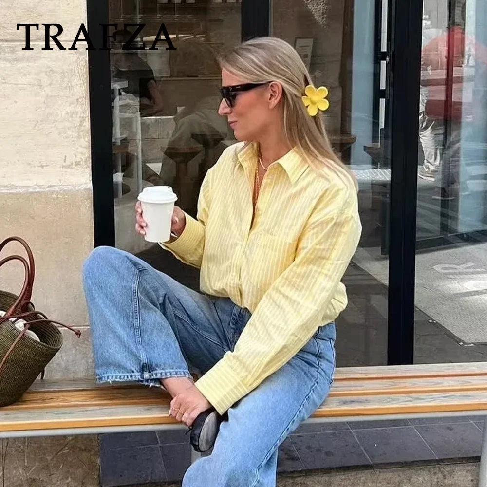 Stylish woman enjoying coffee in a TRAFZA Casual Women Striped Butter Yellow Shirt Vintage Thin Fabric Turn-Down Collar.