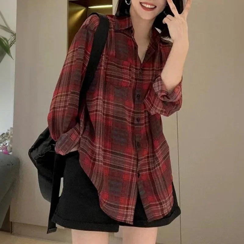 Stylish woman wearing a Breezy Oversized Plaid Shirt for Women Long Sleeve Collared Button-Down Blouse, perfect for summer.