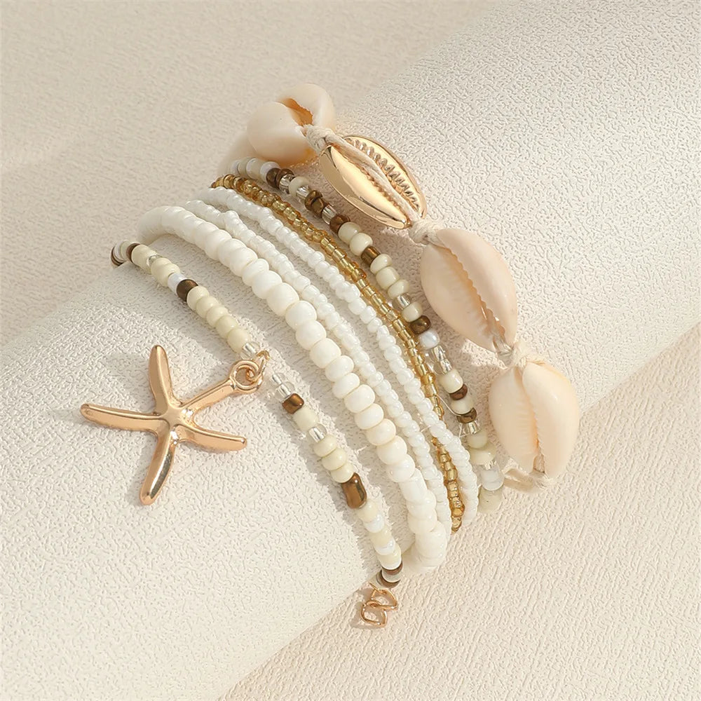 Trendy handcrafted beach jewelry for women featuring the 7 Piece Stackable Starfish Pendant Bracelet Set with mini seed beads.