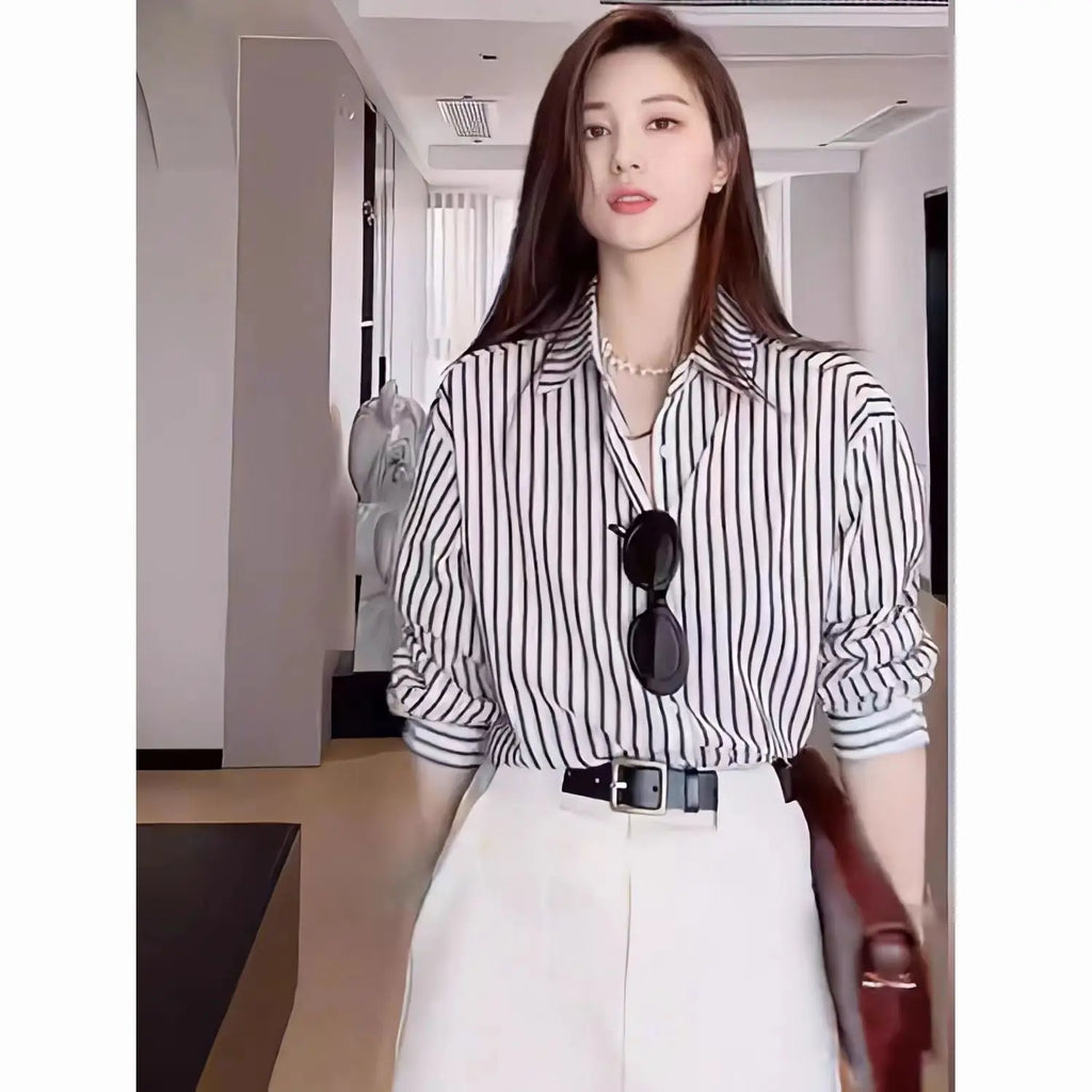 Stylish woman wearing an Elegant Black Striped Blouse for Women Casual Long-Sleeve Office Shirt, perfect for sophistication.