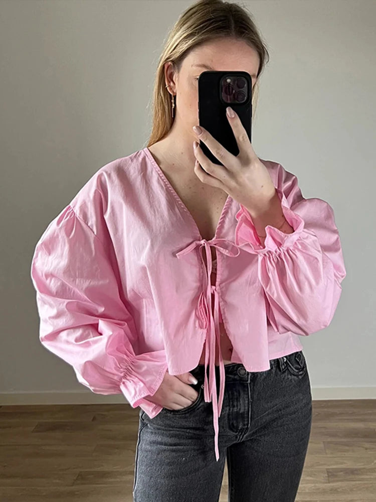 Chic and stylish, this Elegant Solid Lace-Up V-Neck Blouse for Women features lantern sleeves and a loose fit perfect for summer.