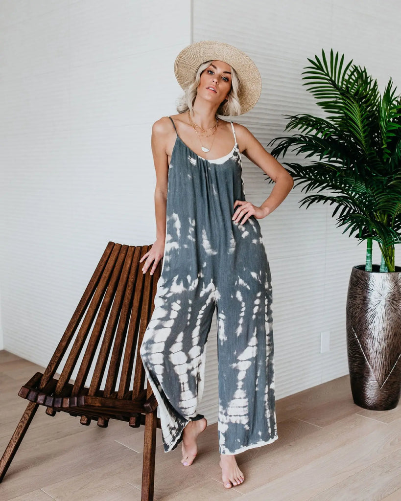 Stylish woman in a Women’s Sexy Suspender Jumpsuit with Wide Leg Pants Elegant Chic Sleeveless Romper, perfect for summer.