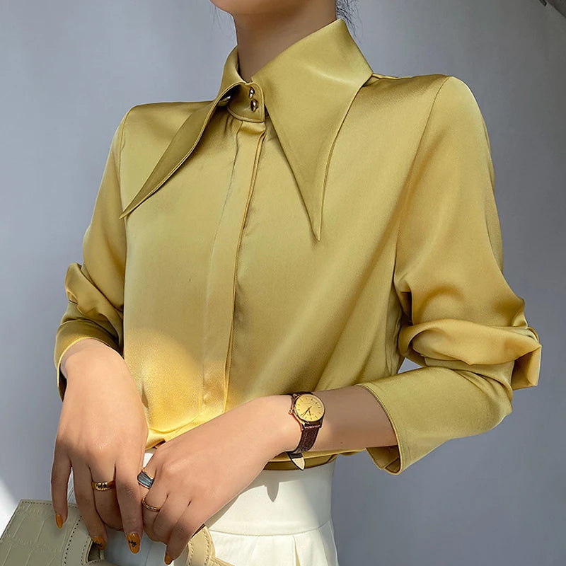 Chic and sophisticated, the Elegant Turn Down Collar Satin Silk Blouse features a vintage button closure and lantern sleeves.