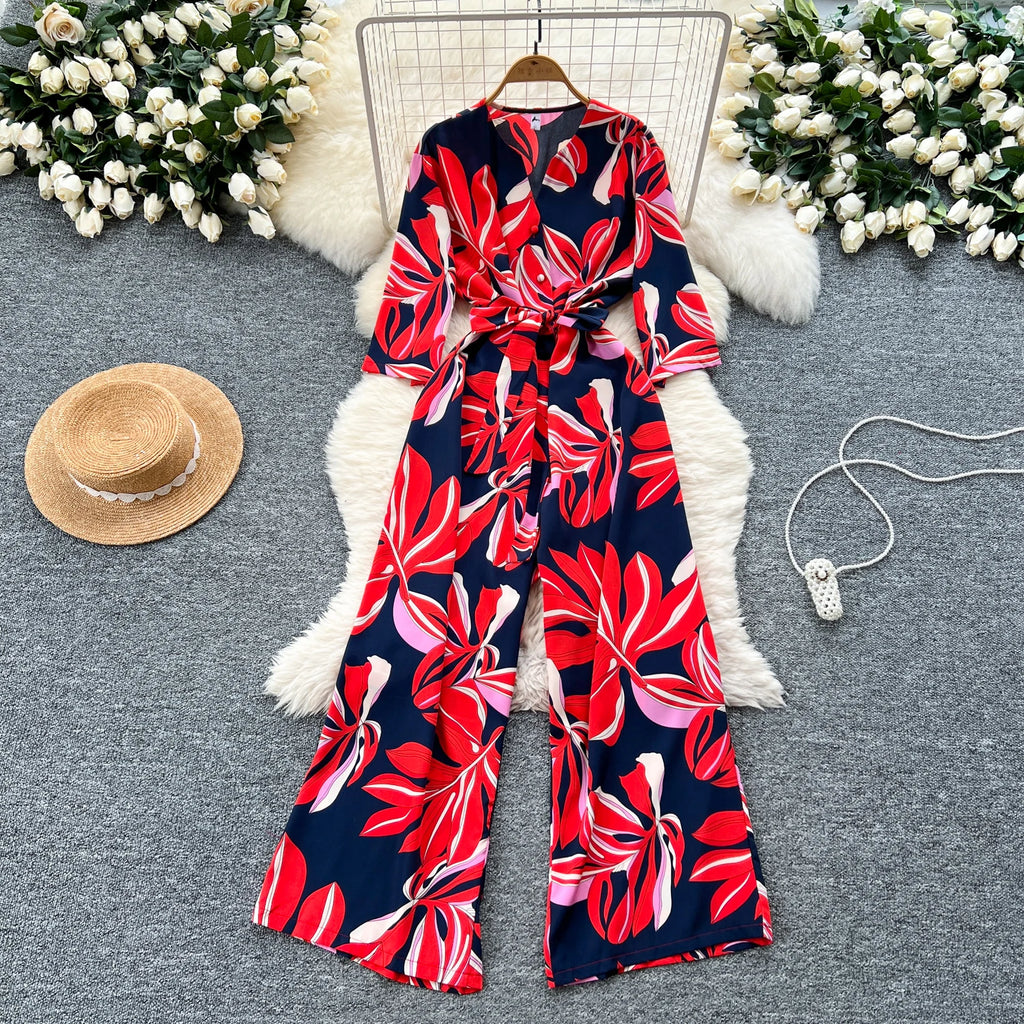 Floral Women’s Summer V-Neck Short Sleeve Lace-Up Waist Slim Fit Wide-Leg Printed Jumpsuit with Loose Straight Leg Design.