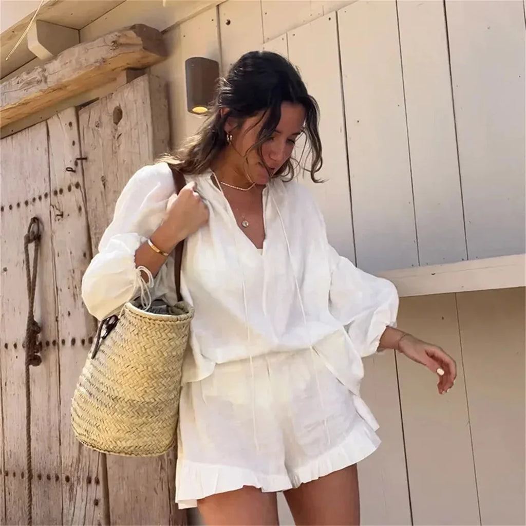 Stylish Women's Casual Cotton Linen Two-Piece Beach Set with Loose Ruffle Shorts and Long Sleeve Drawstring Pullover.