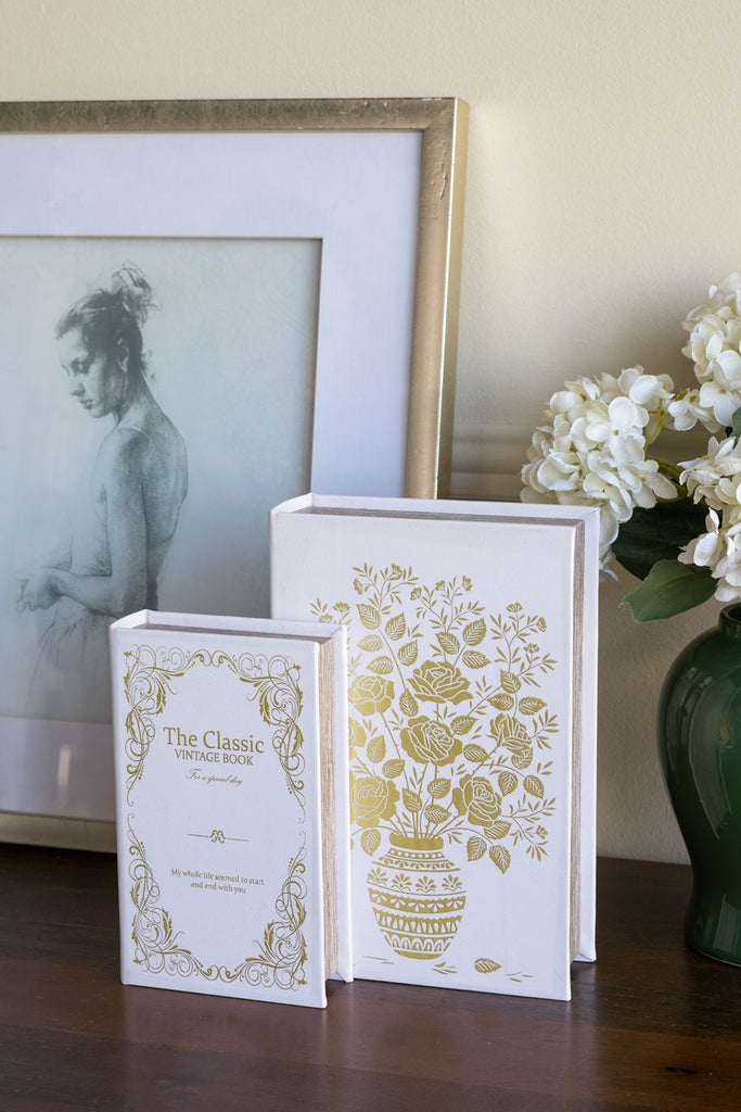 Set of 2 Decorative Book Boxes with White and Gold Floral Motifs and Text, L: 7x3x10.5" S: 5x2x8.3"