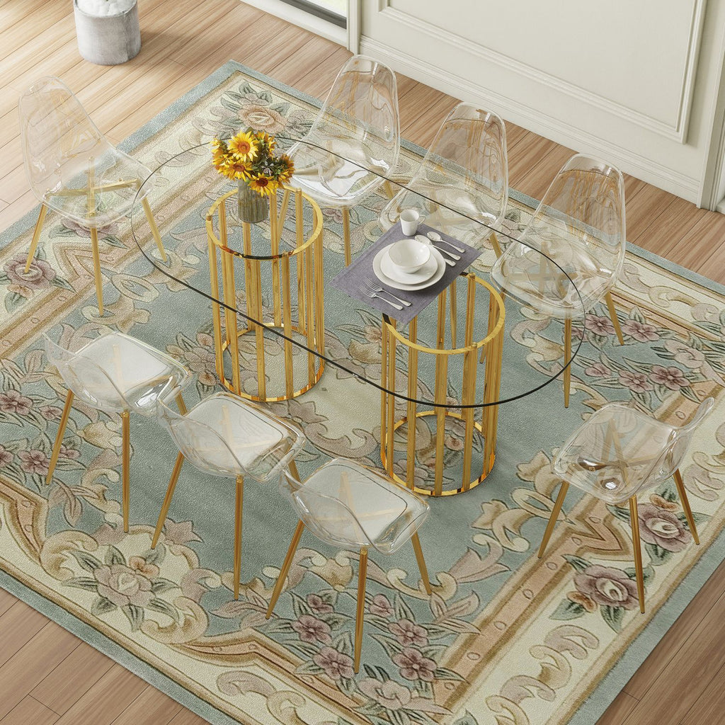 Table and chair set.71 inch oval tempered glass dining table,gold double column light luxury style. Paired with 8 Transparent Plastic Chairs with Golden Metal Legs.