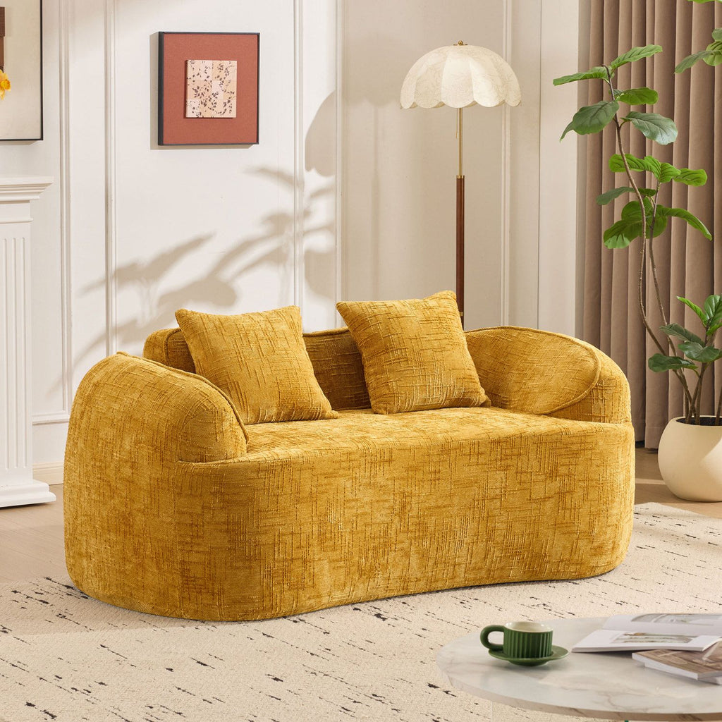 Yellow curved two - person compress sofa. It has armrests on both sides, comes with two pillows, is suitable for small - sized apartments, and can be placed in the living room or bedroom.